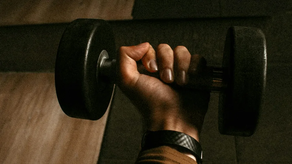 Hand gripping a dumbbell